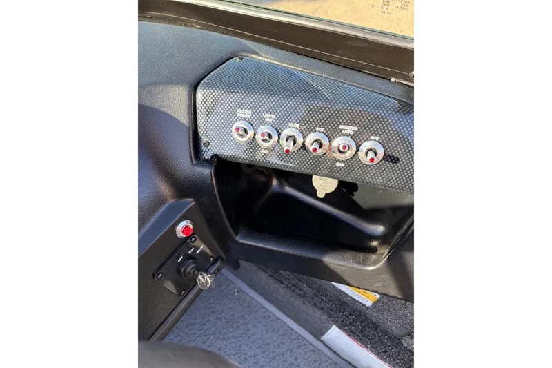 Slide: The Image of Control panel of 2026 Lowe Fishing Machine 1775WT boat with switches and key ignition. - 8