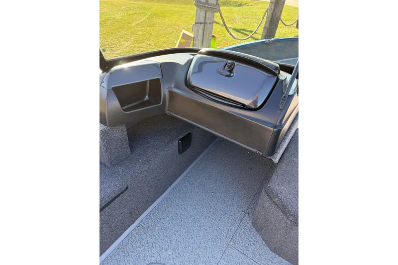 Slide: The Image of 2026 Lowe Fishing Machine 1775WT interior with storage compartment and carpeted flooring. - 9