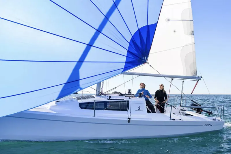 The Image of Manufacturer Provided Image: 2026 Beneteau First 24 sailboat with blue and white sails on open water. - 0
