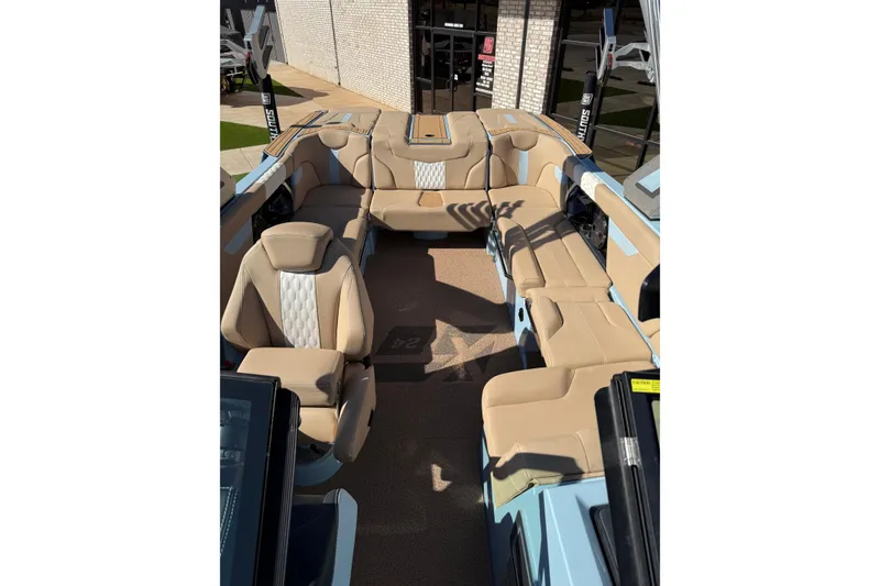 Slide: The Image of 2022 MasterCraft XT24 boat interior with beige seating and modern design. - 10
