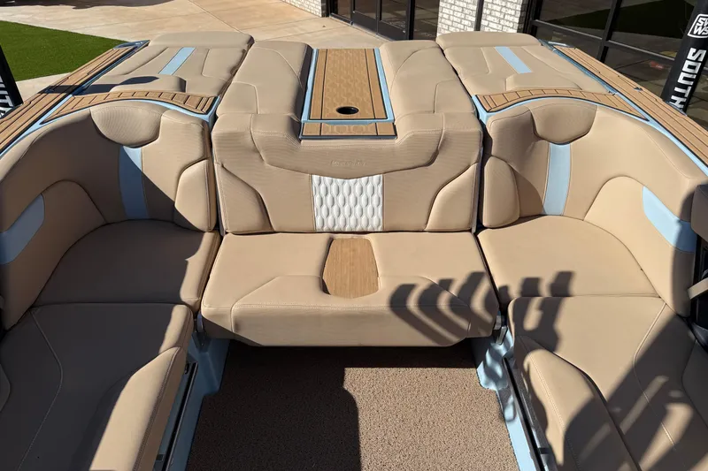 Slide: The Image of 2022 MasterCraft XT24 boat interior with beige and blue seating, featuring elegant design. - 11