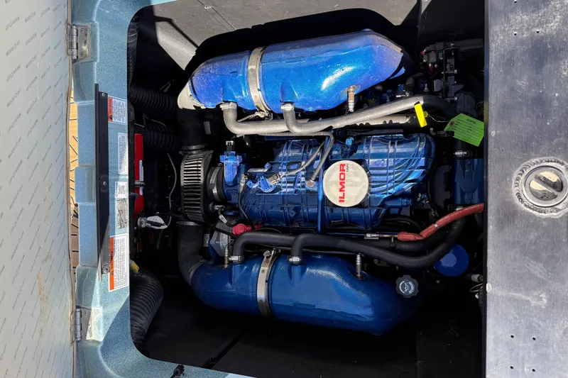 Slide: The Image of 2022 MasterCraft XT24 engine compartment with Ilmor marine engine, showcasing blue components. - 17