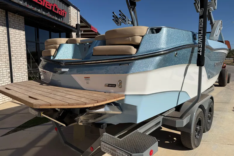 Slide: The Image of 2022 MasterCraft XT24 boat on trailer, featuring sleek design and spacious seating. - 18