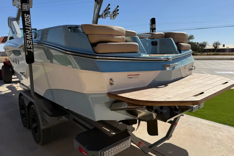 Slide: The Image of 2022 MasterCraft XT24 boat on trailer, rear view with swim platform. - 20