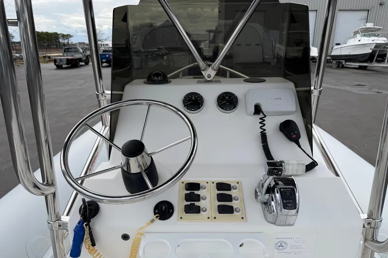 Slide: The Image of Control panel of a 2006 HBI 22 boat with steering wheel and gauges. - 10