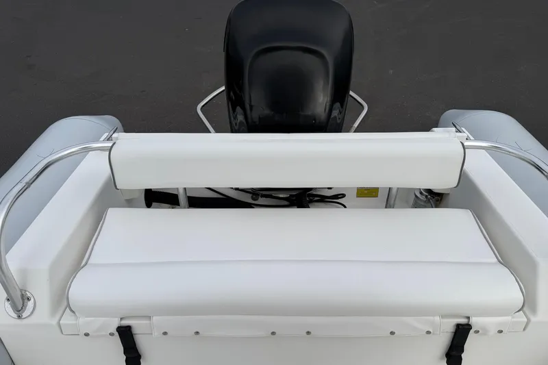 Slide: The Image of White seating area on a 2006 HBI 22 boat with black motor. - 12