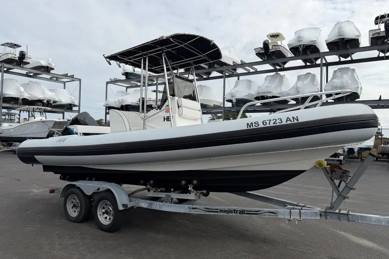 Slide: The Image of 2006 HBI 22 boat on trailer in marina storage, surrounded by stacked boats. - 3