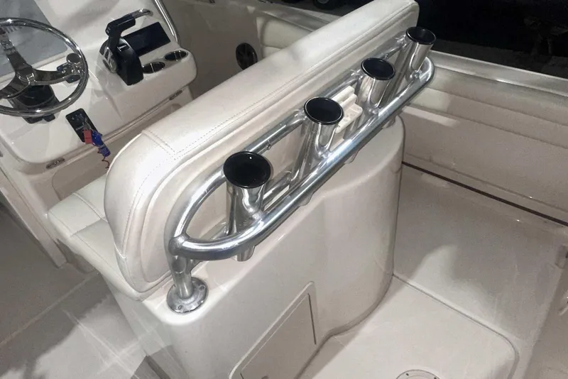 Slide: The Image of 2021 Grady-White Fisherman 216 boat interior with rod holders and steering console. - 17