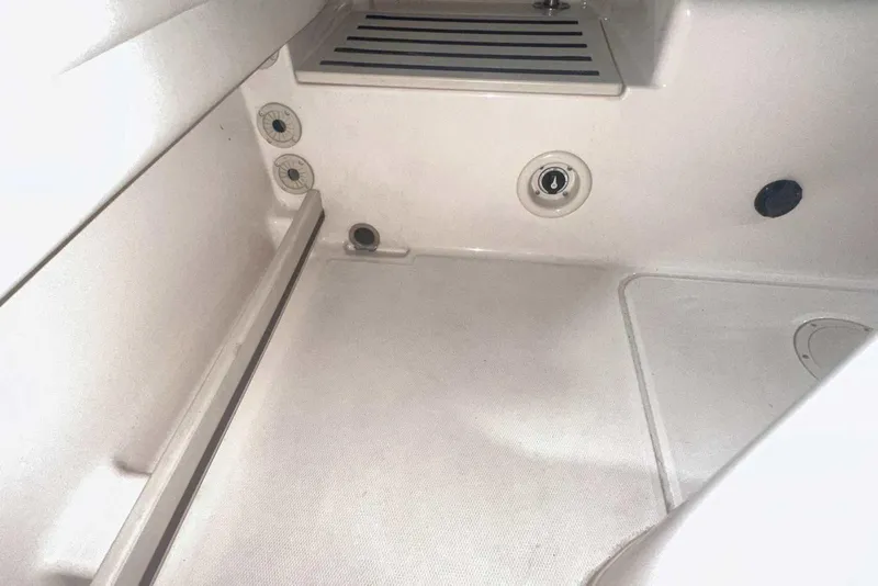 Slide: The Image of 2021 Grady-White Fisherman 216 boat interior, featuring storage compartment and drainage system. - 18