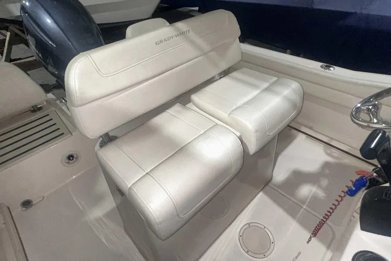 Slide: The Image of 2021 Grady-White Fisherman 216 boat interior with cushioned seating and steering area. - 21