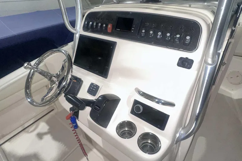 Slide: The Image of 2021 Grady-White Fisherman 216 boat console with steering wheel and control panel. - 24