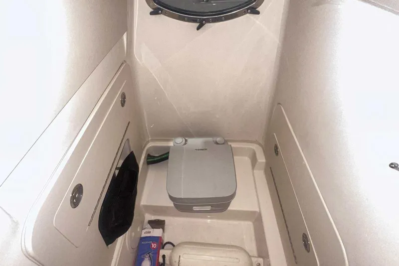 Slide: The Image of 2021 Grady-White Fisherman 216 boat interior with portable toilet and storage compartments. - 30
