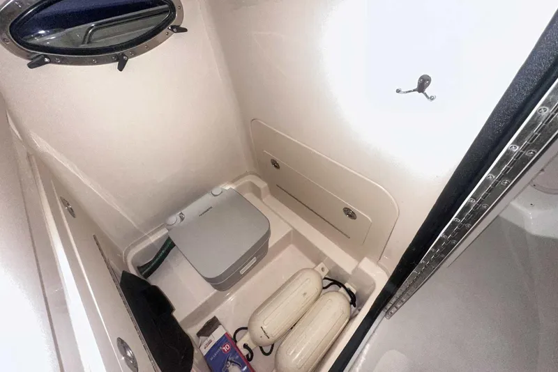 Slide: The Image of 2021 Grady-White Fisherman 216 boat storage compartment with portable toilet and accessories. - 31