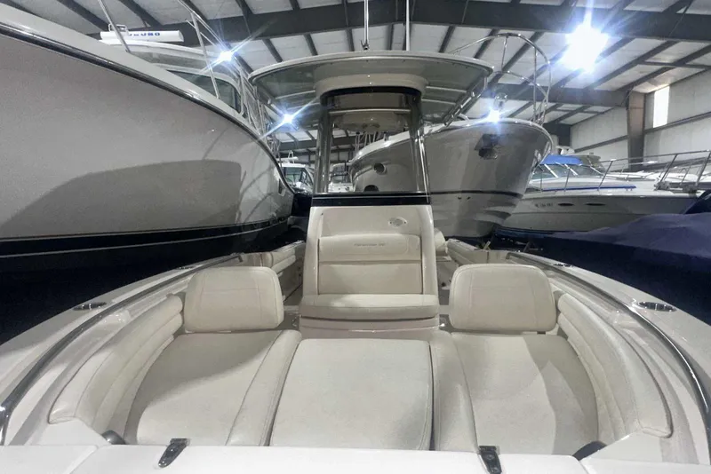 Slide: The Image of 2021 Grady-White Fisherman 216 boat interior with cushioned seating in a showroom. - 35
