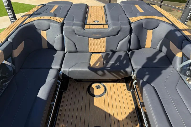Slide: The Image of 2023 MasterCraft XT24 boat interior with luxurious seating and stylish design. - 13