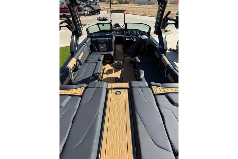 Slide: The Image of 2023 MasterCraft XT24 boat interior with luxurious seating and modern design. - 14