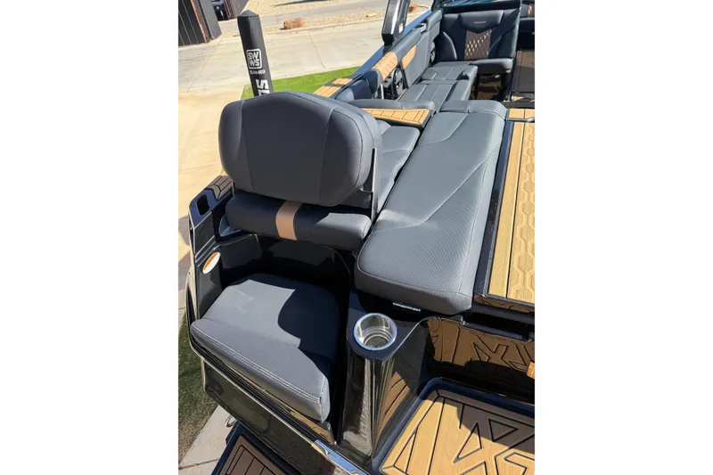 Slide: The Image of 2023 MasterCraft XT24 boat interior with luxurious seating and cup holder. - 15