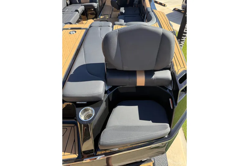 Slide: The Image of 2023 MasterCraft XT24 boat seat with cup holder and sleek design. - 16