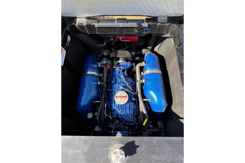 Slide: The Image of 2023 MasterCraft XT24 engine compartment with blue Ilmor engine components. - 18