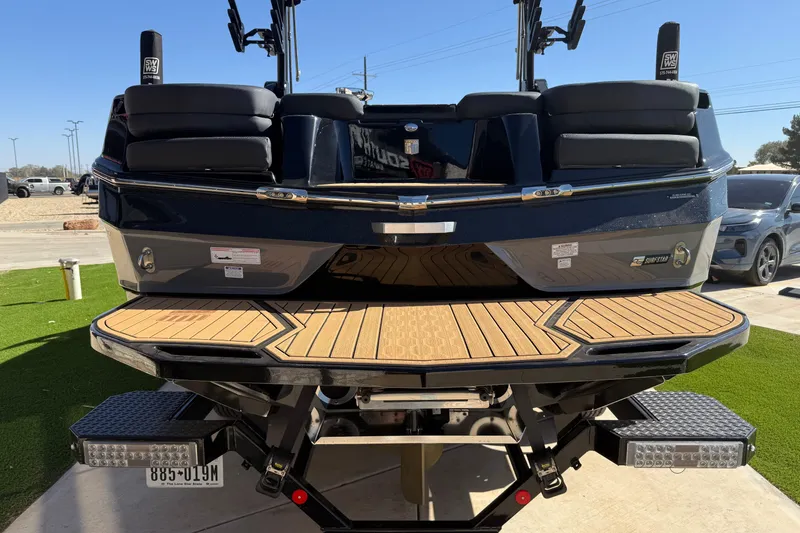 Slide: The Image of 2023 MasterCraft XT24 boat rear view with teak swim platform. - 19