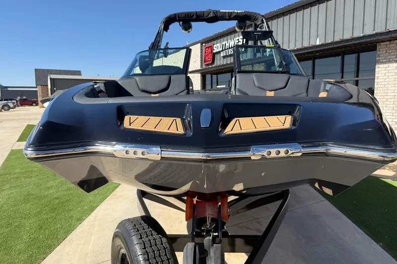 Slide: The Image of 2023 MasterCraft XT24 boat on trailer, front view, outdoors at dealership. - 6