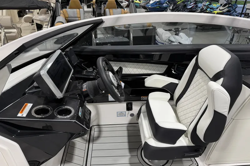 Slide: The Image of 2025 Yamaha Boats 275SE cockpit with modern steering, touchscreen, and luxurious seating. - 5