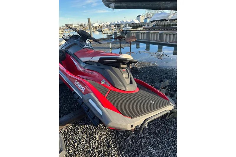 Slide: The Image of 2023 Yamaha WaveRunner VX Deluxe in red, parked near a marina. - 6