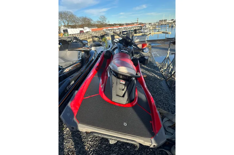 Slide: The Image of 2023 Yamaha WaveRunner VX Deluxe in red, parked near a marina. - 9