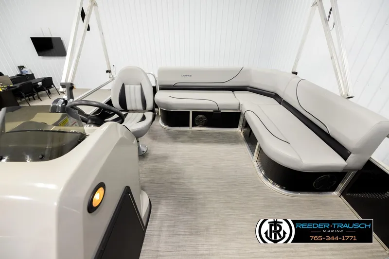 Slide: The Image of 2024 Lowe Ultra 162 Fish & Cruise pontoon boat interior with seating and steering console. - 14