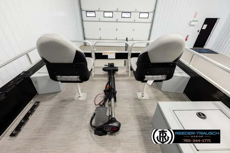 Slide: The Image of 2024 Lowe Ultra 162 Fish & Cruise boat interior with seating and motor in showroom. - 18