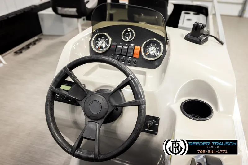 Slide: The Image of 2024 Lowe Ultra 162 Fish & Cruise boat dashboard with steering wheel and gauges. - 28