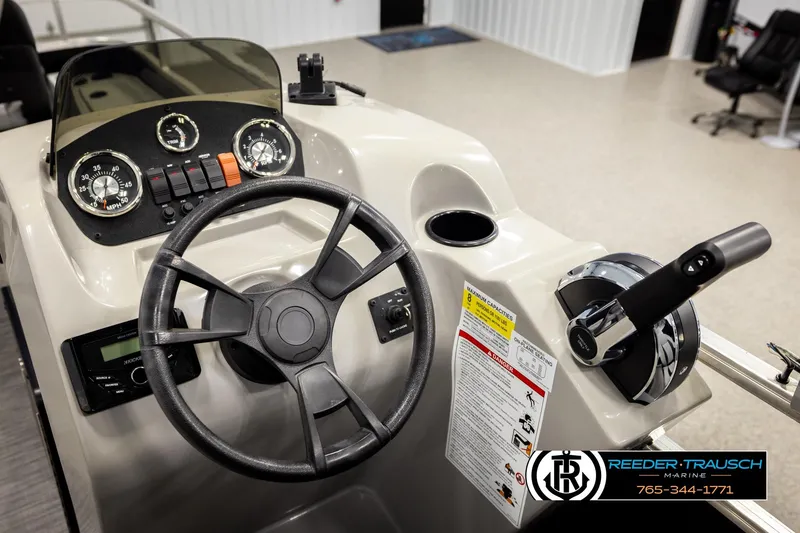 Slide: The Image of 2024 Lowe Ultra 162 Fish & Cruise boat dashboard with steering wheel and controls. - 29