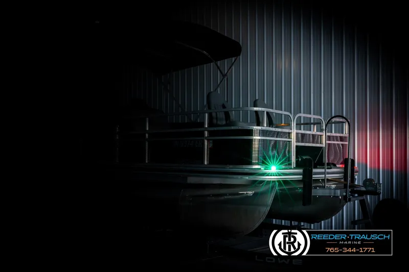 Slide: The Image of 2024 Lowe Ultra 162 Fish & Cruise pontoon boat in dimly lit showroom. - 4