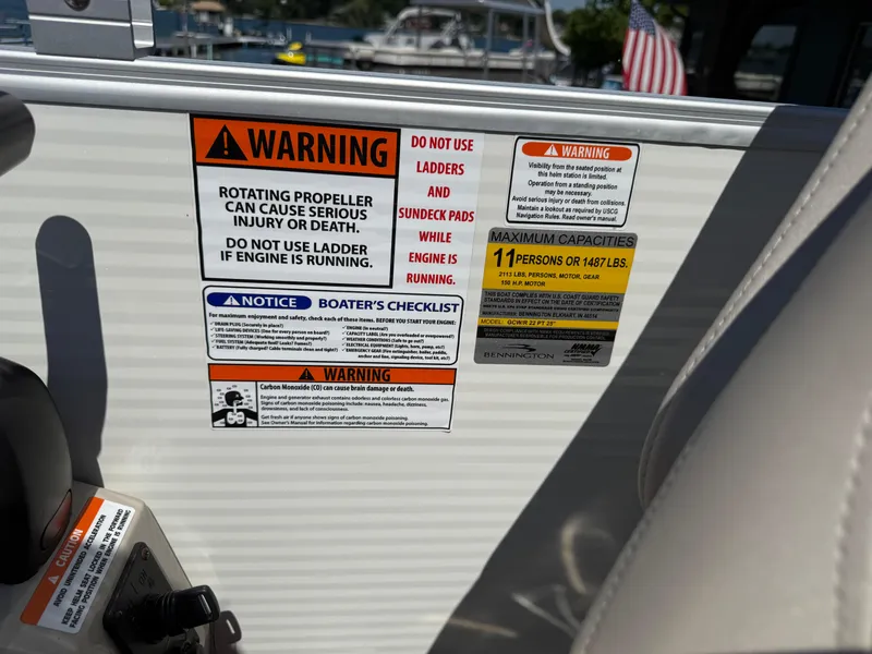 Slide: The Image of Warning labels on a 2017 Bennington G22 boat, highlighting safety and capacity information. - 13