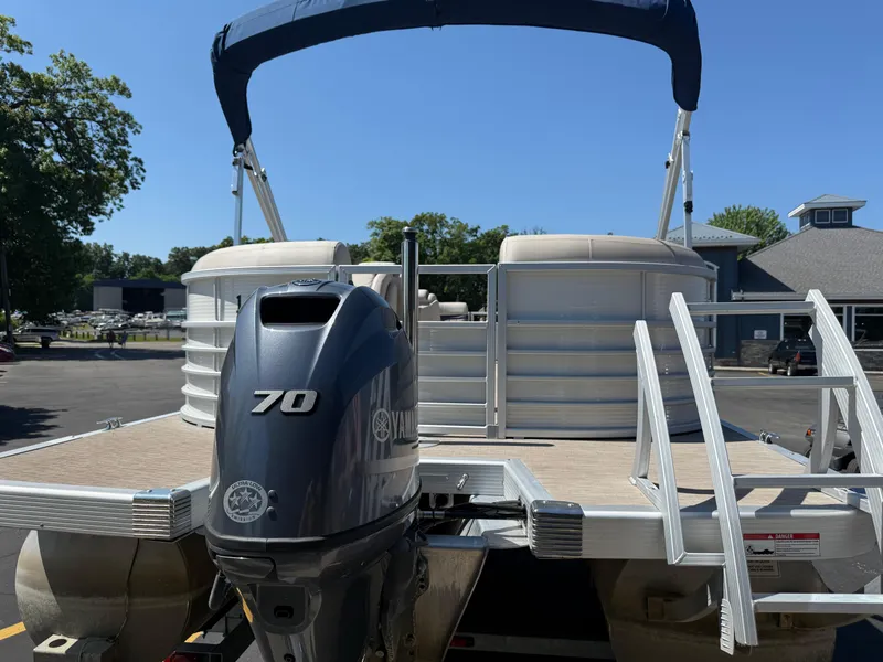 Slide: The Image of 2017 Bennington G22 pontoon boat with Yamaha 70 outboard motor, docked under blue sky. - 3