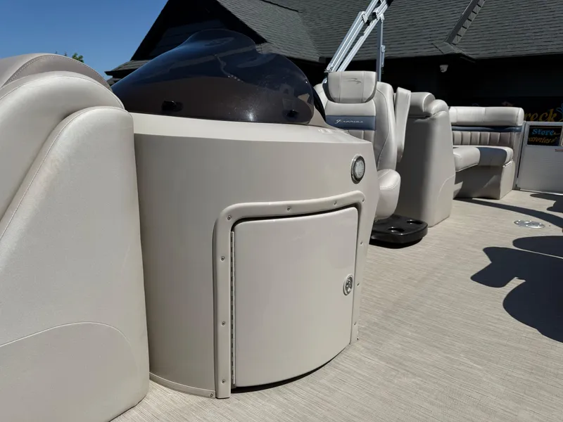 Slide: The Image of 2017 Bennington G22 pontoon boat interior with helm and seating, showcasing luxury design. - 7