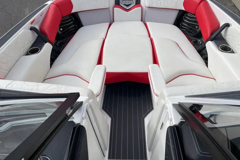 Slide: The Image of 2023 Nautique Super Air Nautique G25 Paragon interior with red and white seating. - 11