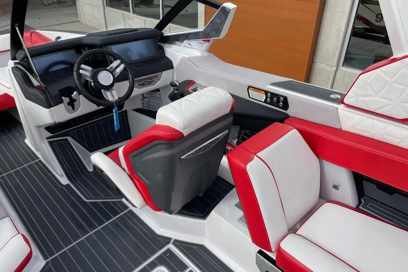 Slide: The Image of 2023 Nautique Super Air Nautique G25 Paragon interior with red and white seating, modern dashboard. - 6