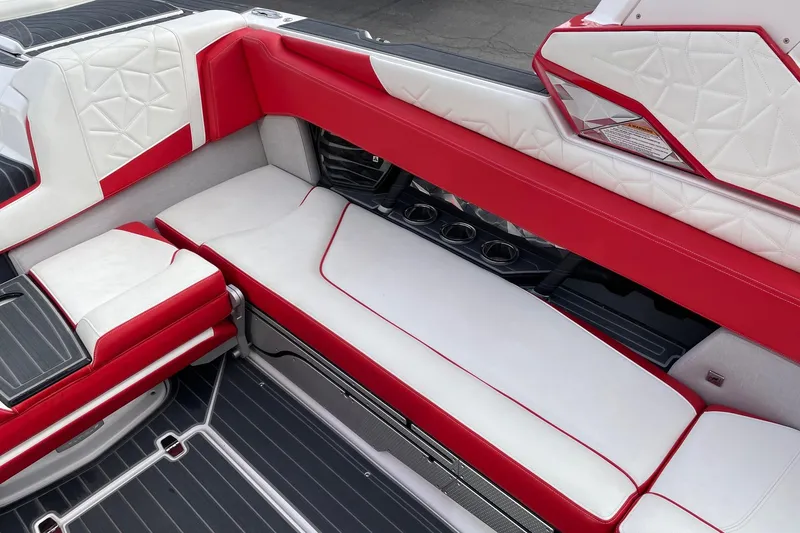 Slide: The Image of 2023 Nautique Super Air Nautique G25 Paragon interior with red and white seating. - 9