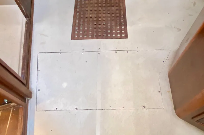 Slide: The Image of Floor of 1994 Island Packet 44 sailboat with wooden grate and access panel. - 101