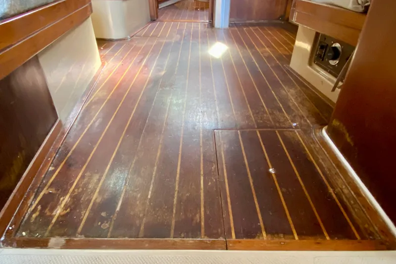 Slide: The Image of Interior view of 1994 Island Packet 44 sailboat with wooden flooring. - 102