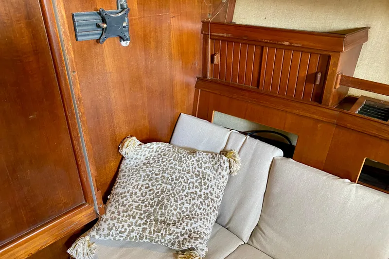 Slide: The Image of Interior of 1994 Island Packet 44 yacht with wooden paneling and patterned cushion. - 105