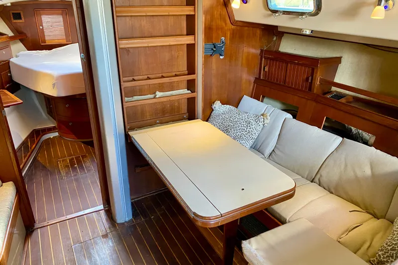 Slide: The Image of Cozy interior of 1994 Island Packet 44 sailboat with wooden furnishings and seating area. - 106