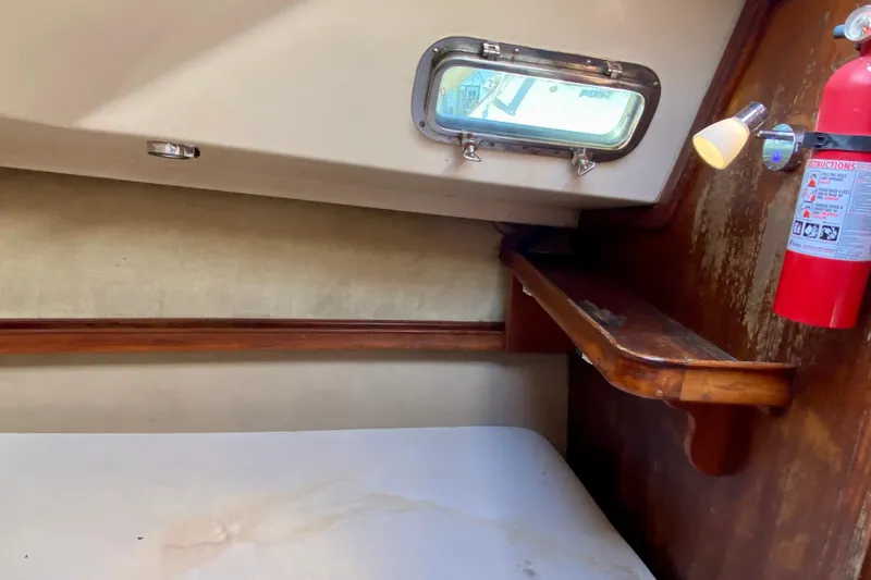 Slide: The Image of Interior cabin of 1994 Island Packet 44 sailboat with porthole and fire extinguisher. - 110