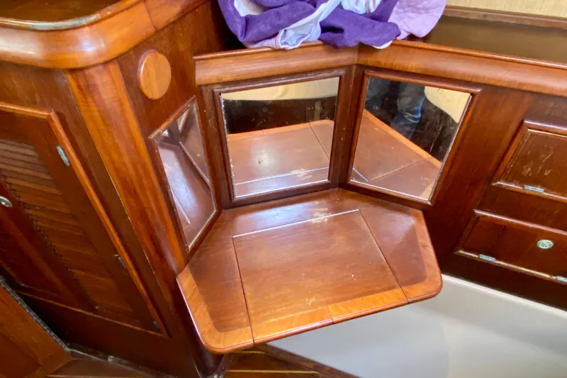 Slide: The Image of Wooden vanity area with mirrors on a 1994 Island Packet 44 yacht. - 111