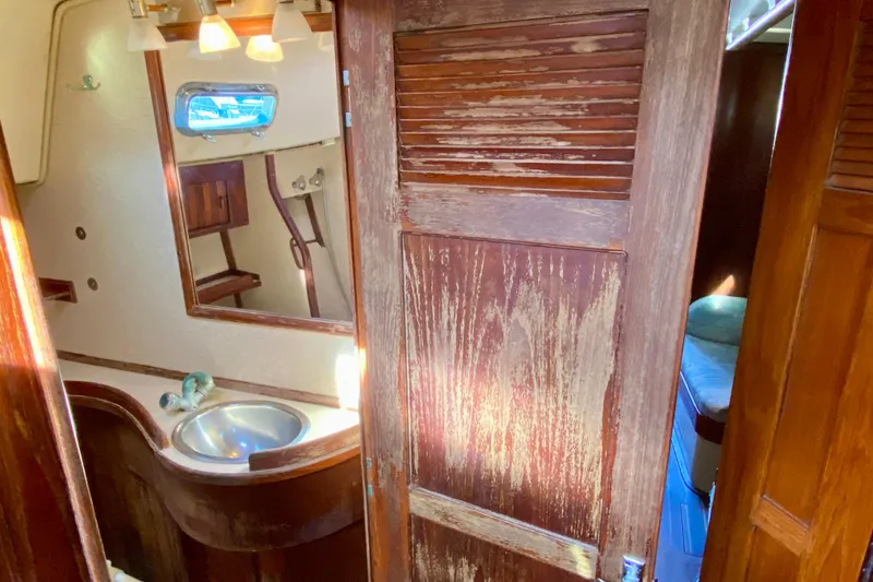 Slide: The Image of Interior of 1994 Island Packet 44 sailboat with wooden bathroom and sink. - 113