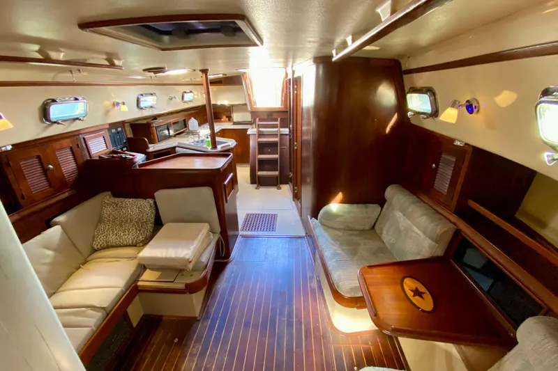 Slide: The Image of Interior of 1994 Island Packet 44 sailboat with cozy seating and wooden finishes. - 117
