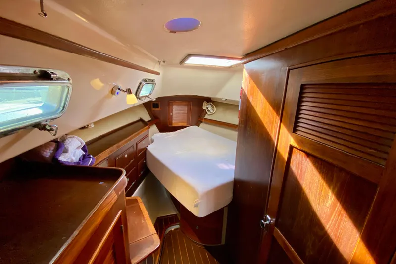 Slide: The Image of Cozy cabin interior of 1994 Island Packet 44 sailboat with wooden furnishings. - 118