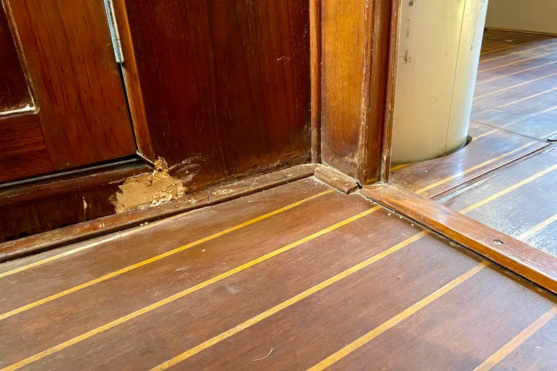 Slide: The Image of Damaged wooden interior of 1994 Island Packet 44 sailboat, showing wear and repair. - 120