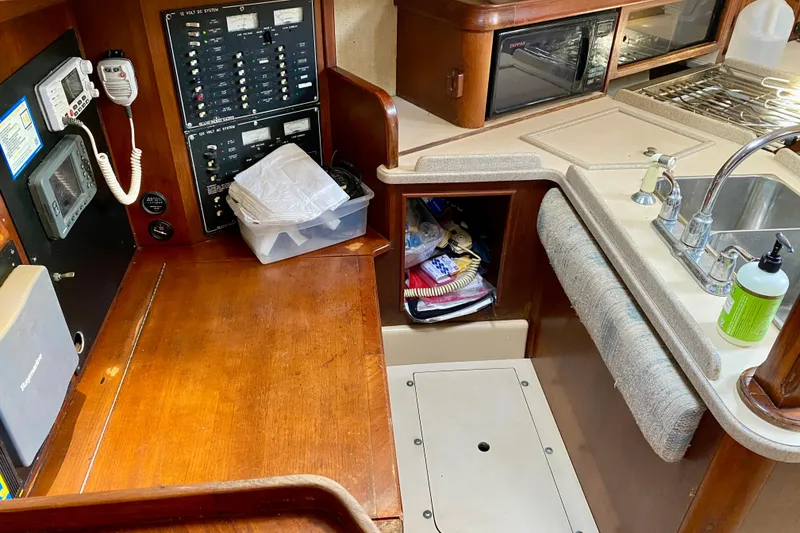 Slide: The Image of Interior of 1994 Island Packet 44 sailboat with navigation station and galley area. - 123